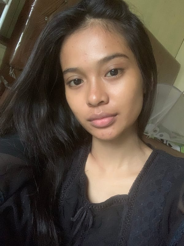 Woman takes multiple selfies indoors in Sungai Meriam, Indonesia