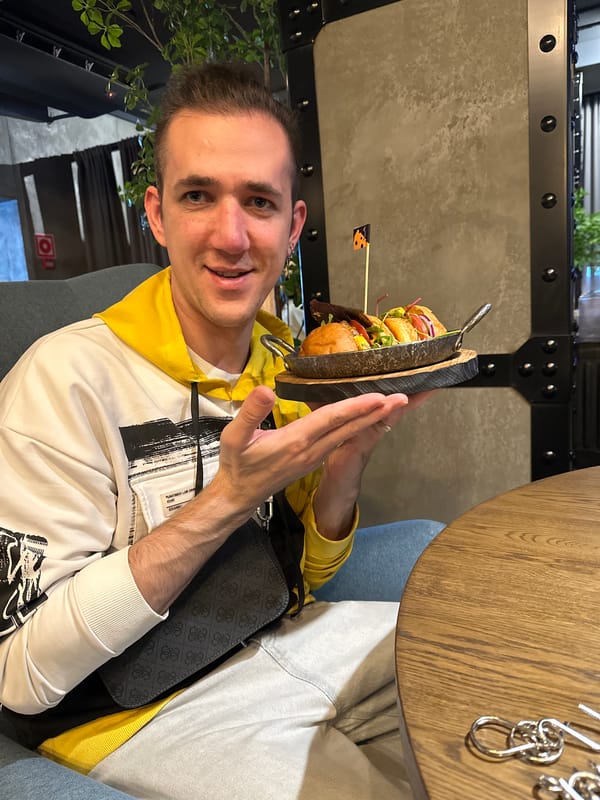 Man holds stacked burger presentation in Saratov restaurant