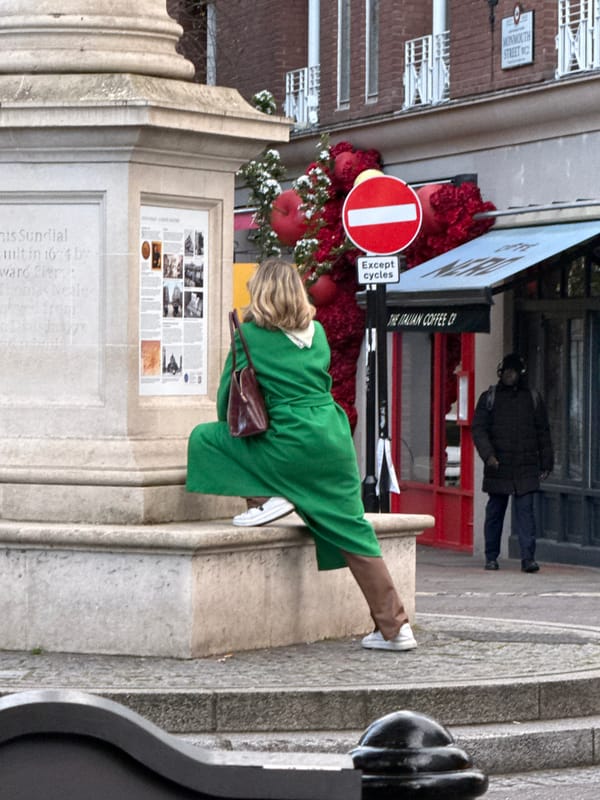 Woman visits monument on Monmouth Street, London