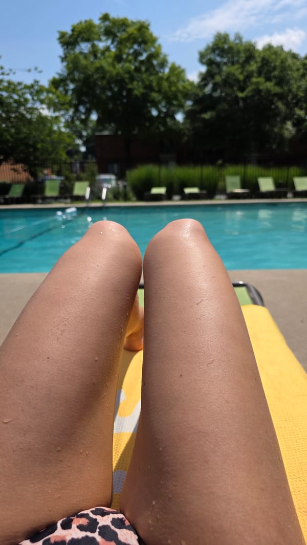 Lazy afternoon poolside, sun-soaked and dripping dry