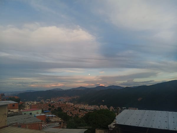 Caracas hillside barrios at dusk, valley and mountains beyond