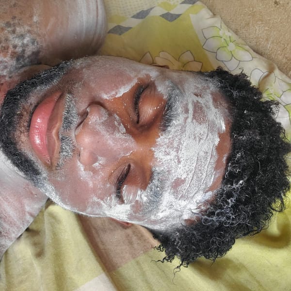 Man receives facial treatment with white substance in Obosi