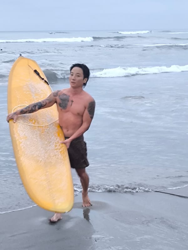 Surfer with yellow board spotted on Canggu beach