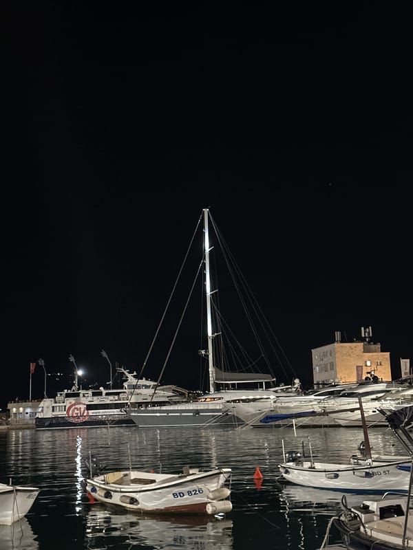 Budva evening: marina lights, old town streets, and band rehearsal