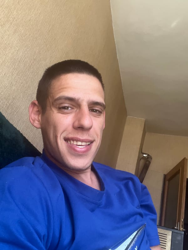 Man in blue shirt photographed with scissors in Sofia