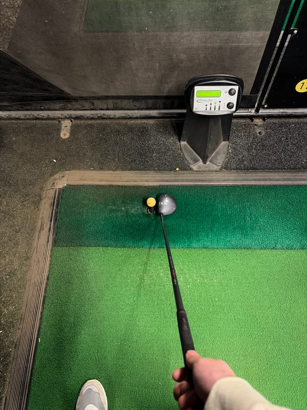 Golfer practices at Suffolk resort using simulators, driving range