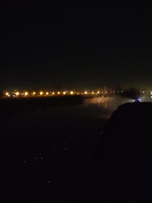 Nighttime streetlights illuminate waterfront in Yakhroma, Russia