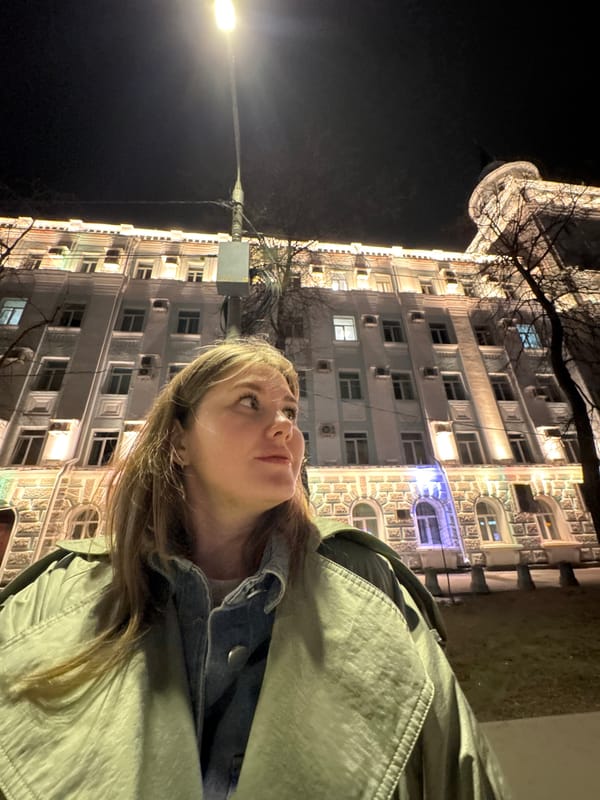 Evening gathering outside illuminated building in Perm, Russia