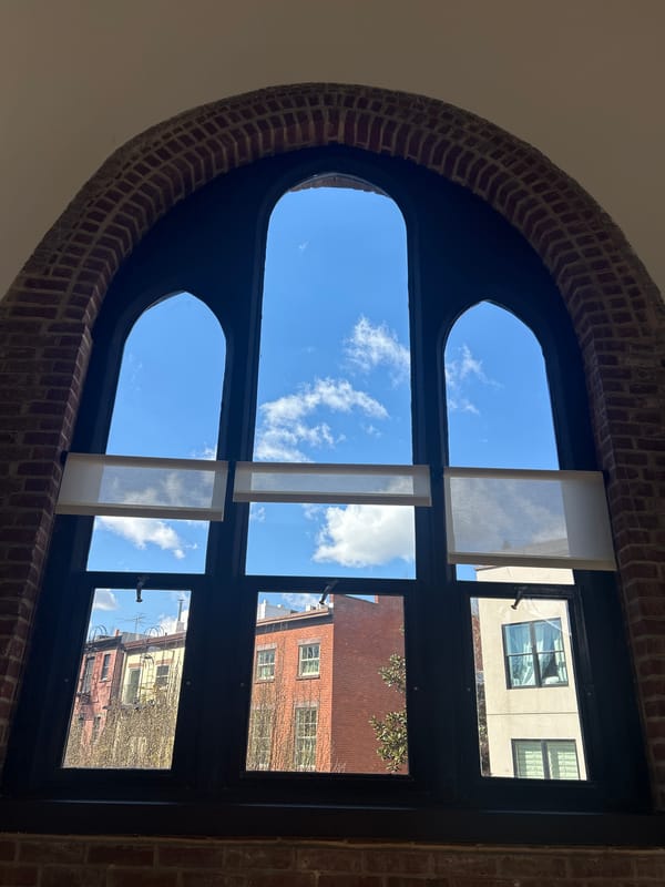 Arched stained glass window observed in NYC building
