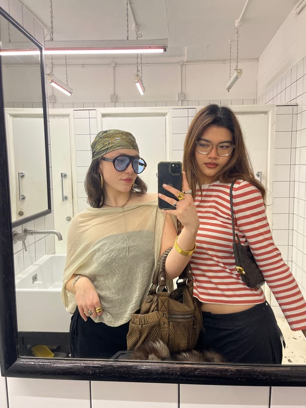 Two women take mirror selfie in London indoor space