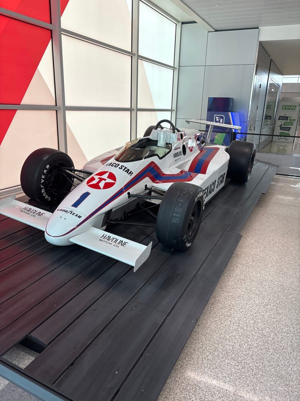 Vintage race car with sponsor logos displayed in Indianapolis
