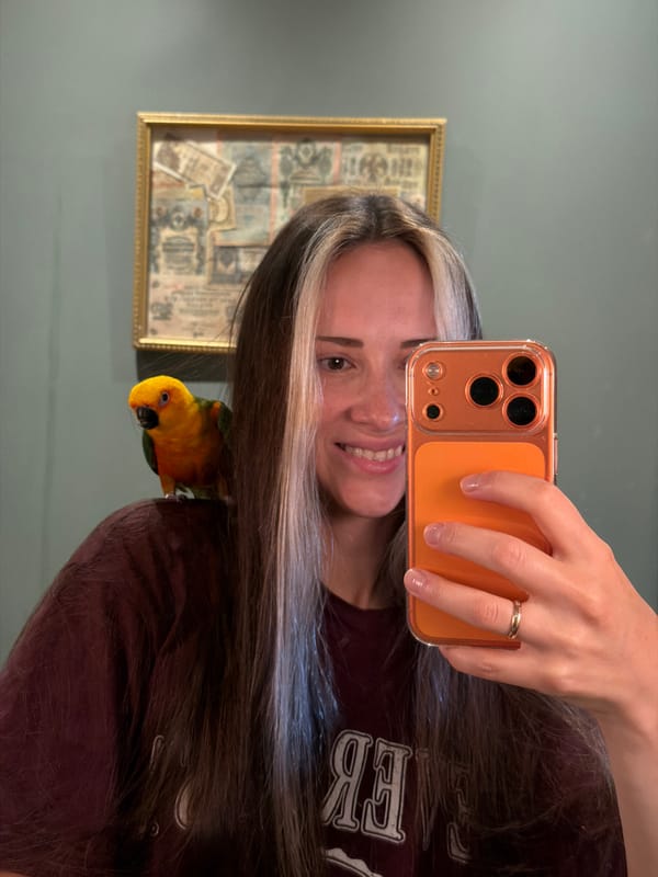 Person poses with colorful parrot in Khimki home