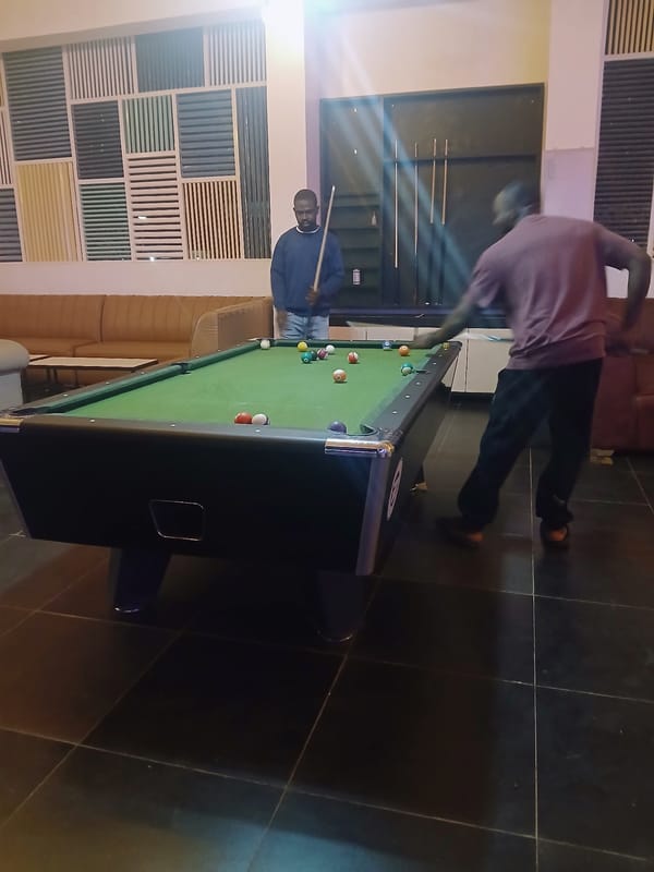 Men play pool at indoor venue in Kitwe