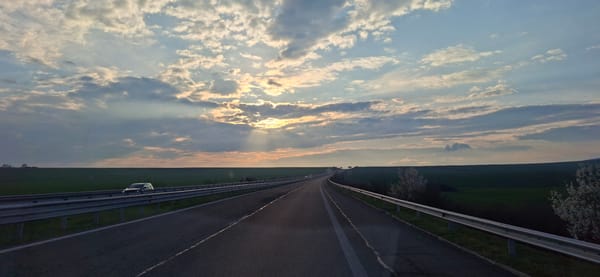 Rural road through green fields captured in Vratitsa, Bulgaria