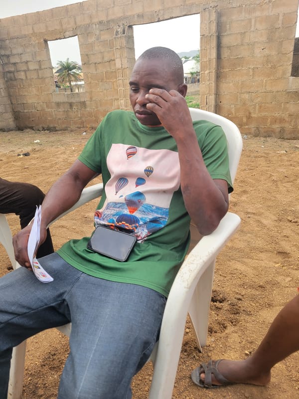 Community gathering with paperwork in Madalla, Nigeria