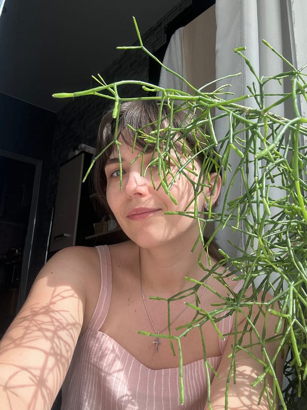 Woman poses with plant in Saint Petersburg apartment