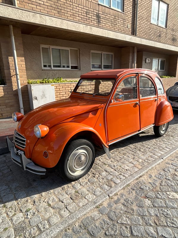 Coastal afternoon: beaches, a 2CV, and a scallop shell marker