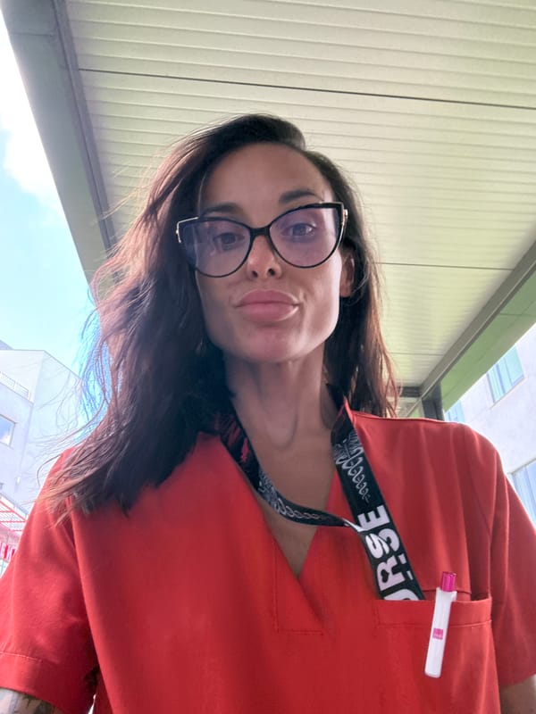 Nurse in orange scrubs photographed outdoors in Pleven, Bulgaria