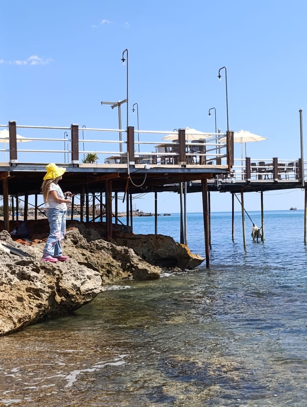 Woman enjoys morning at scenic Antalya pebble beach