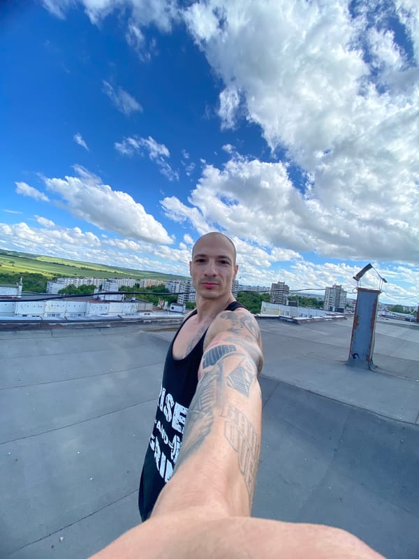 Person frames sky and landscape with black frame in Pleven