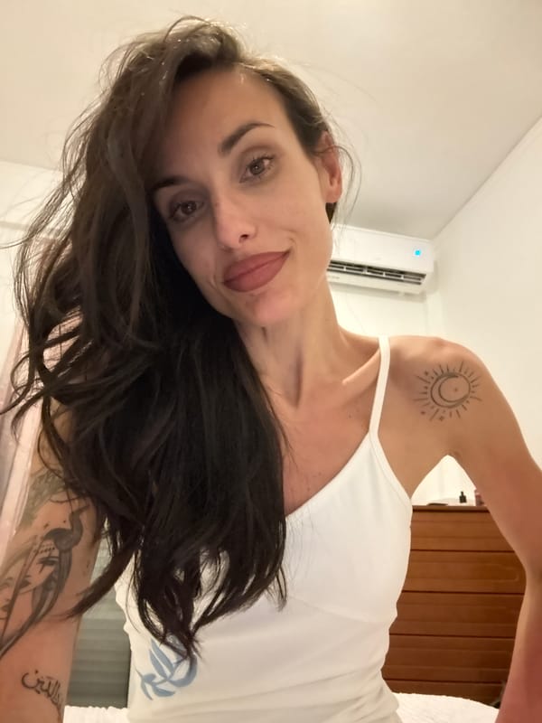 Tattooed woman observed resting indoors in Chania, Greece