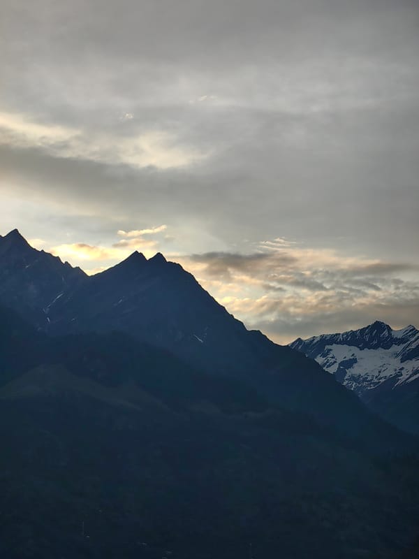 Manali valley and Himalayan peaks on a cloudy summer afternoon