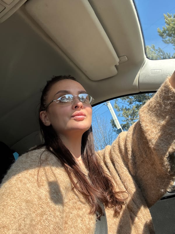 Woman photographed in sunlit car interior in Chaikovsky