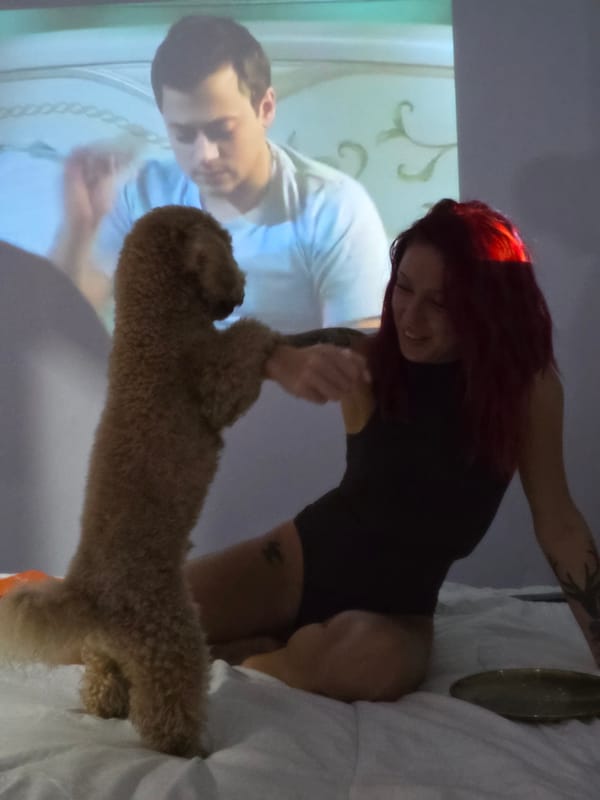 Woman plays with dog in bedroom in Mengwi, Indonesia