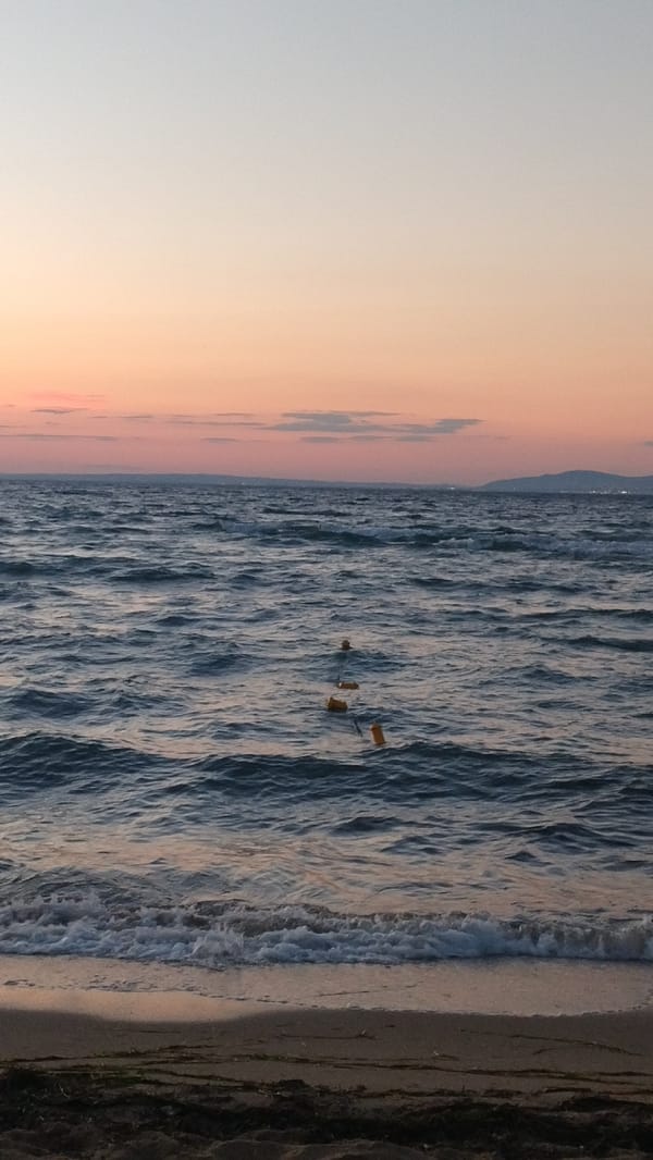 Dusk settles over a quiet beach in Perea, Greece