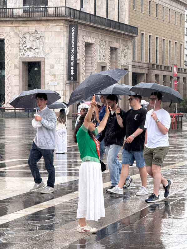 Rainy afternoon scenes documented across central Milan landmarks
