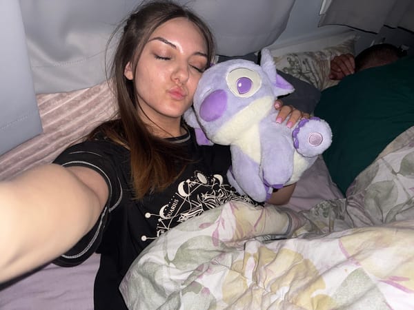 Woman rests with plush toy in Sofia bedroom