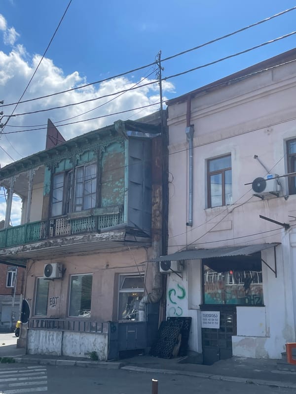 Street life and architecture across a sunny Tbilisi afternoon