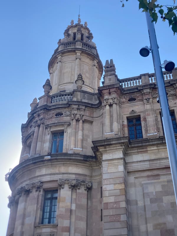 Up-close looks at Barcelona's Correos y Telégrafos building on a sunny afternoon