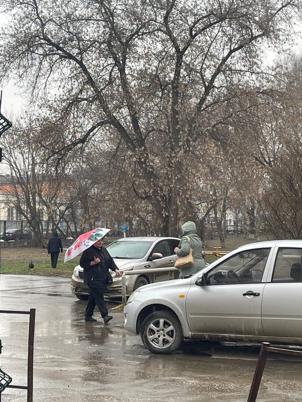 Rainy morning street scene with umbrella in Izhevsk
