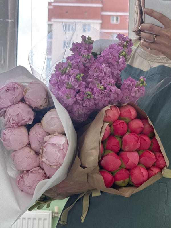 Woman documents flower bouquet collection in Izhevsk shop