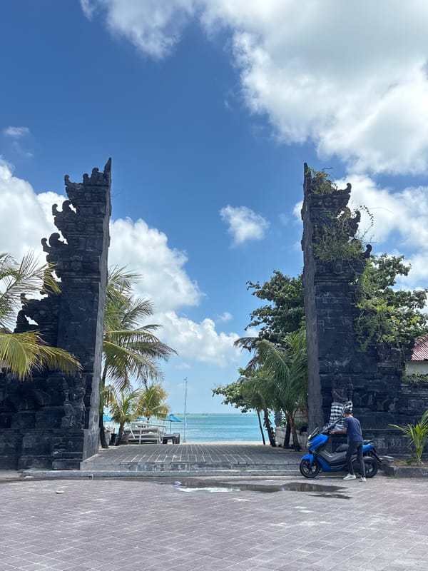 Tourist photographs iconic Kuta gate under morning sky