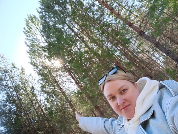 Woman takes forest selfies during spring morning in Dubovaya