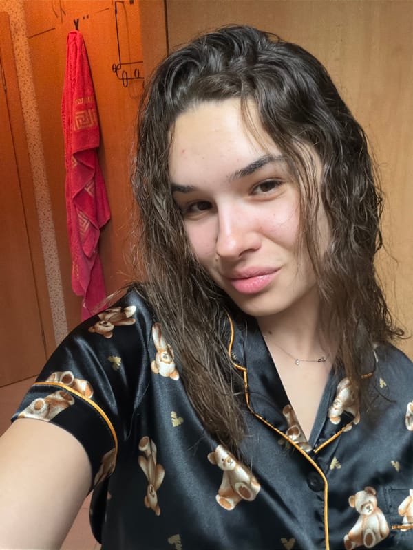 Woman takes playful bedroom selfies in teddy bear pajamas