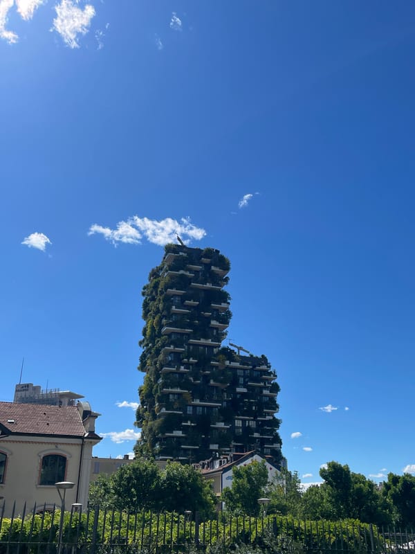 Milan's Vertical Forest towers documented under clear skies