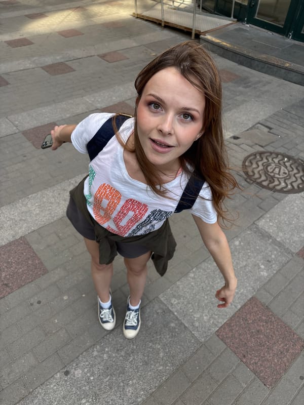 Young women photograph themselves near Saint Petersburg shopping complex