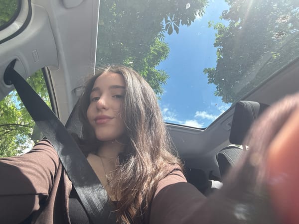 Woman takes selfie in car driver's seat