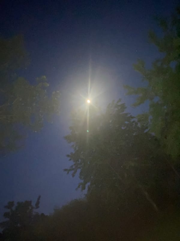 Bright moon observed creating light rays over Buk, Poland