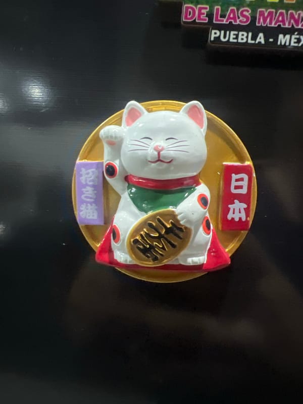 Evening scenes captured in Cholula: lucky cat figurine, sunset