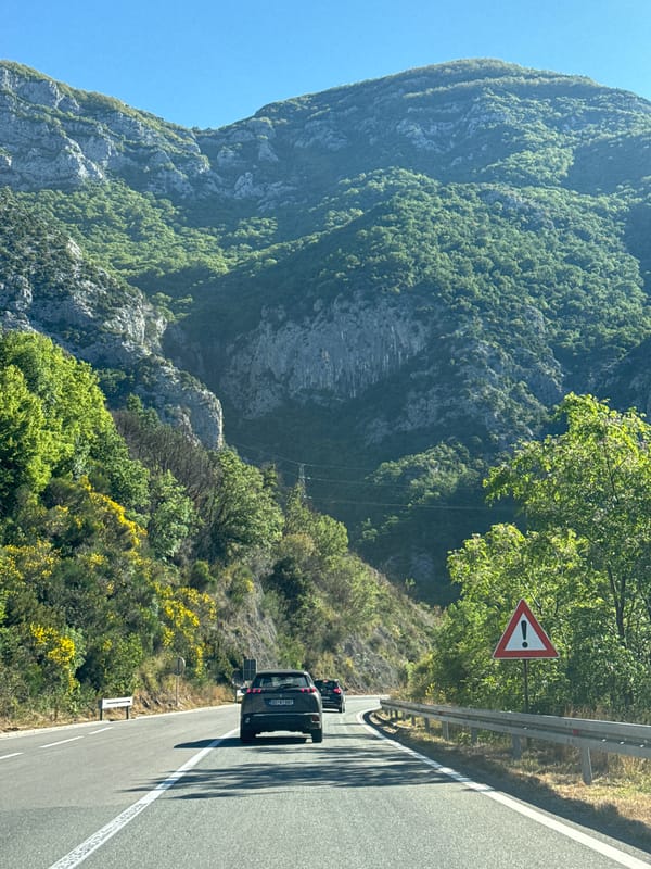 Vehicle travels mountain road in Mišići, Montenegro