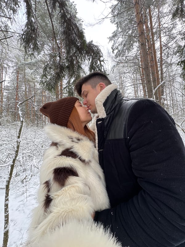 Couple shares intimate moment in snowy Chaikovsky forest
