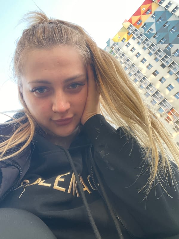 Woman takes selfie in Izhevsk with building backdrop