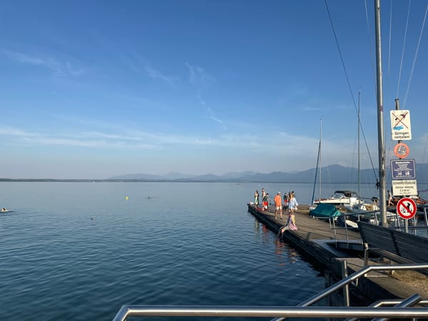 Sunset evening at Lake Chiemsee's marina with champagne and boats