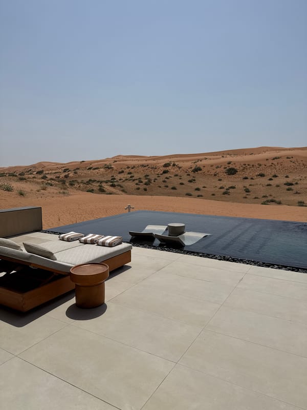 Luxury resort infinity pool and lounge overlooking RAK desert