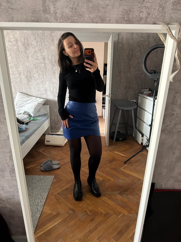 Woman takes mirror selfie with orange phone in Moscow