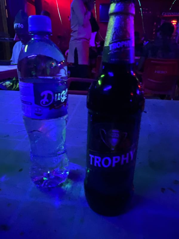 Beer and water bottles photographed under blue light in Nigeria